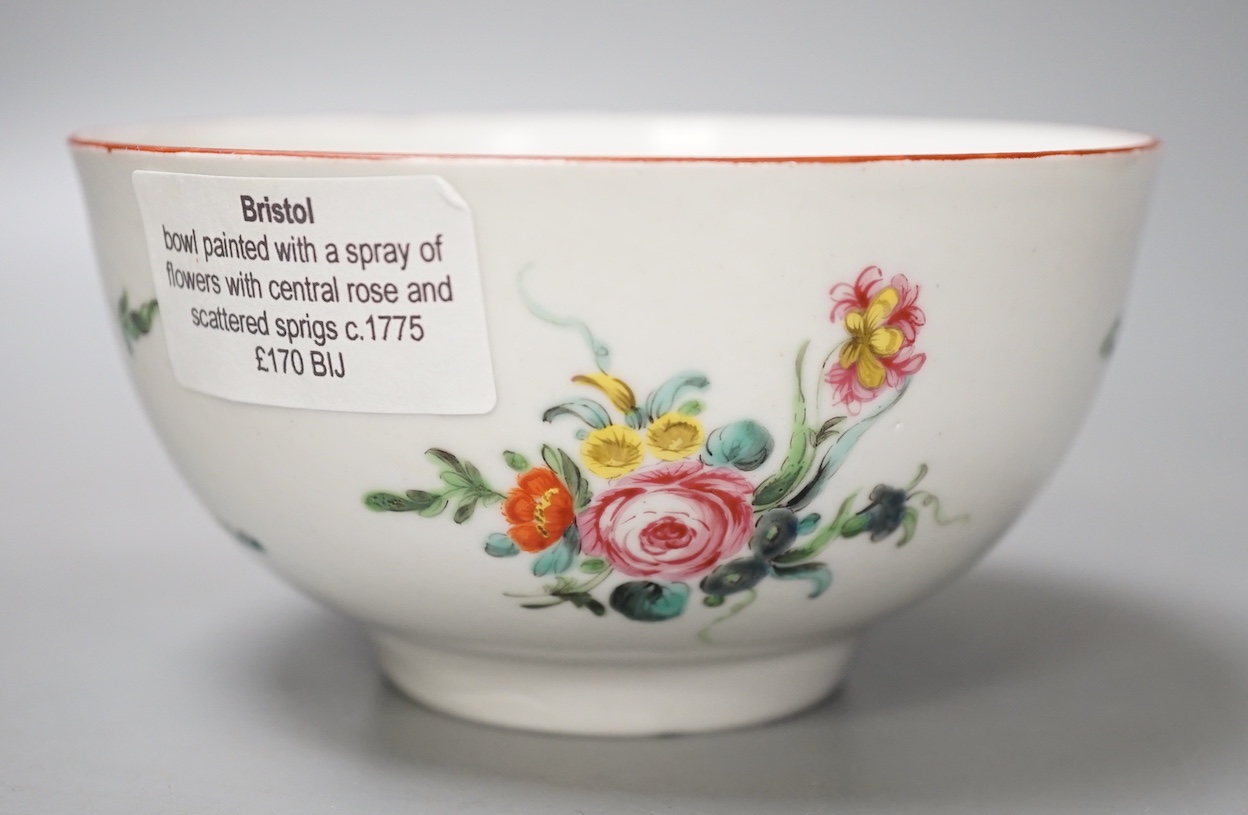 A Bristol porcelain bowl painted with a spray of flowers and scattered sprigs, crossed swords dot mark in under-glaze blue c.1775